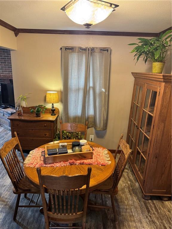 dining area featuring crown molding and wood finished floors