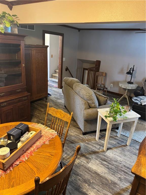 dining area featuring stairway, visible vents, and dark wood finished floors