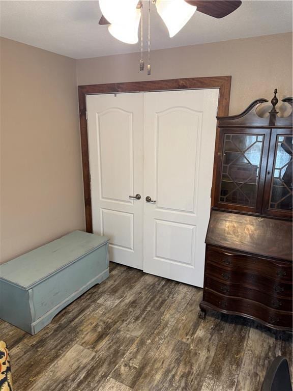 bedroom featuring ceiling fan, a closet, and wood finished floors