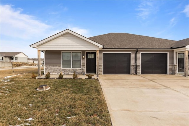 view of front of house with a garage, stone siding, concrete driveway, roof with shingles, and a front lawn