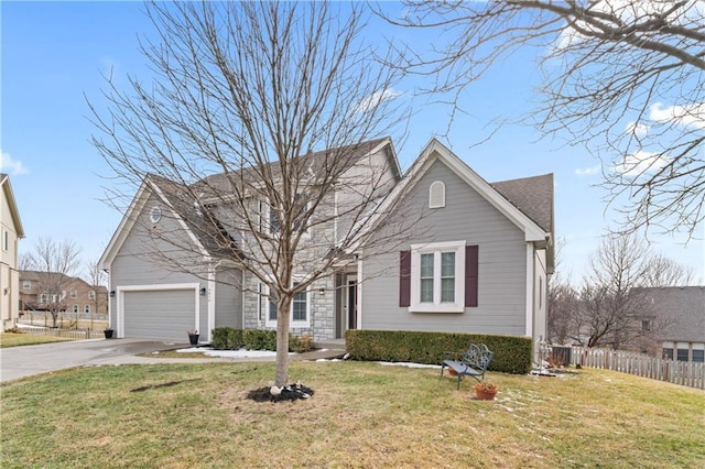 view of front of house with a shingled roof, an attached garage, fence, driveway, and a front lawn