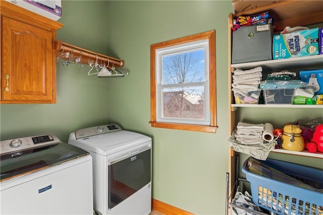 laundry area with washer and dryer and cabinet space