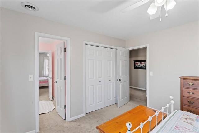 bedroom featuring light colored carpet, a closet, visible vents, and baseboards