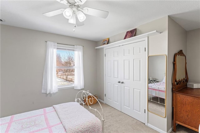 bedroom featuring a closet, carpet flooring, a ceiling fan, and baseboards