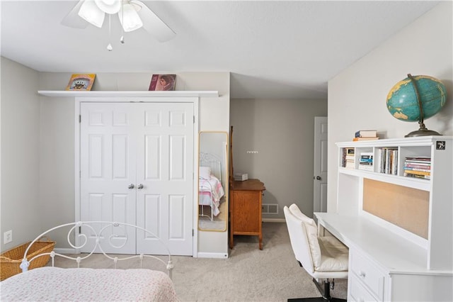 bedroom featuring light carpet, visible vents, baseboards, ceiling fan, and a closet