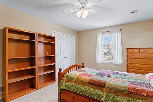 bedroom featuring a ceiling fan, visible vents, and carpet flooring