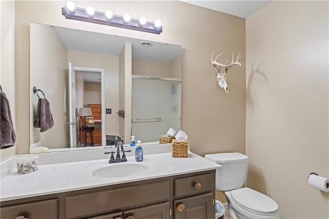 full bath with toilet, an enclosed shower, and vanity