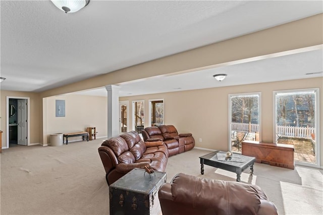 living area featuring baseboards, light carpet, a textured ceiling, and ornate columns