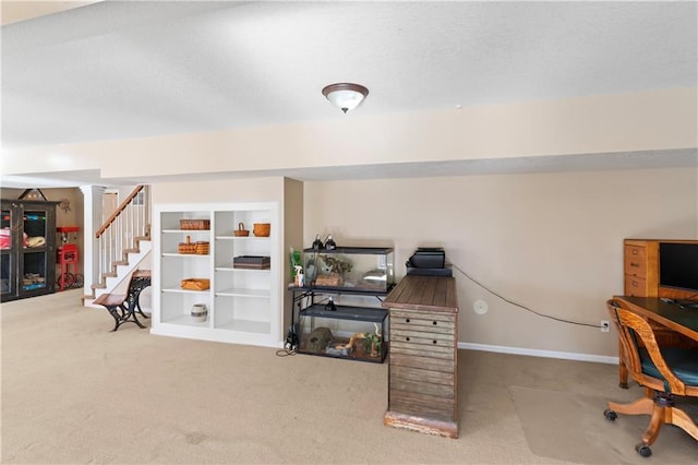 interior space featuring a textured ceiling, carpet flooring, and baseboards