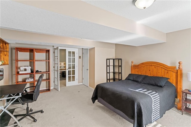 carpeted bedroom featuring a textured ceiling and french doors