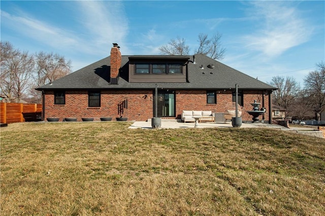 rear view of property featuring brick siding, fence, a lawn, outdoor lounge area, and a patio area