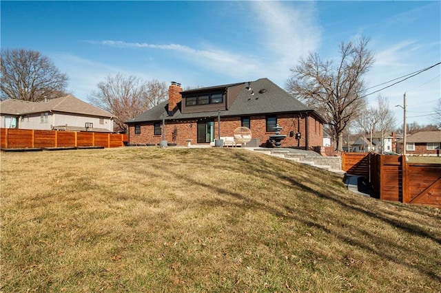 back of house featuring a yard, a patio, a chimney, and fence