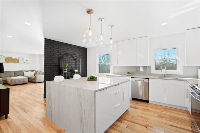 kitchen featuring a sink, white cabinetry, dishwasher, modern cabinets, and range