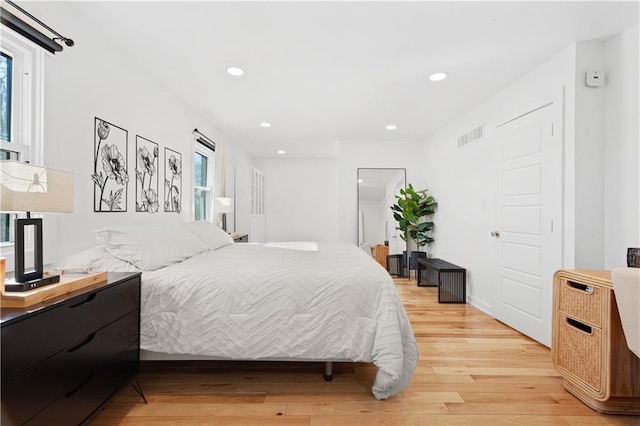 bedroom with recessed lighting, visible vents, and light wood-style flooring