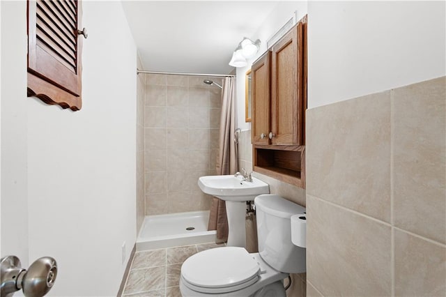 full bath featuring tile patterned flooring, a shower stall, and toilet