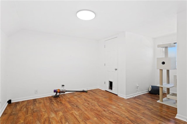 washroom with wood finished floors and baseboards