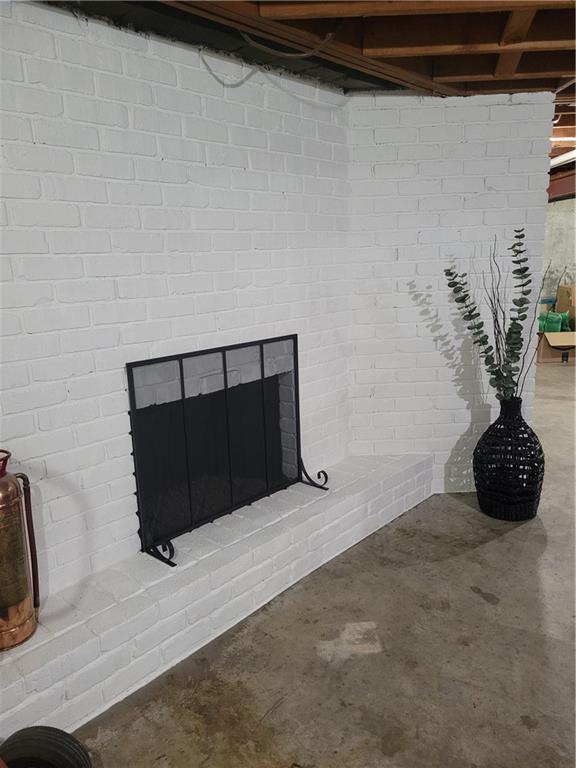 interior details with unfinished concrete flooring and a fireplace