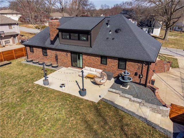 back of house featuring an outdoor living space, roof with shingles, a chimney, a yard, and a patio