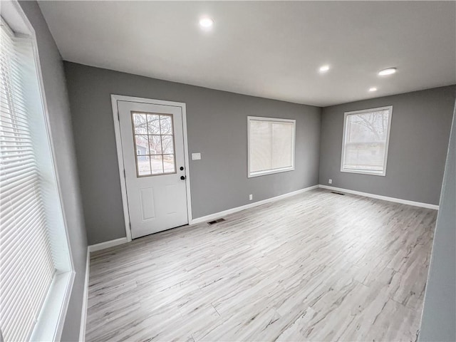 foyer entrance with light wood finished floors, recessed lighting, visible vents, and baseboards