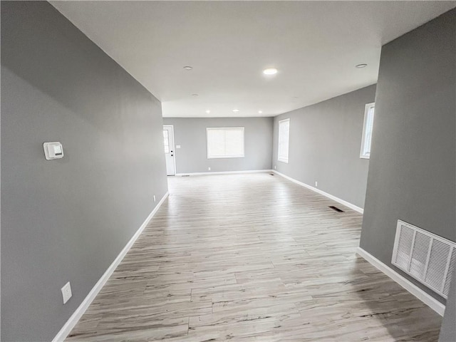 empty room featuring recessed lighting, visible vents, baseboards, and wood finished floors