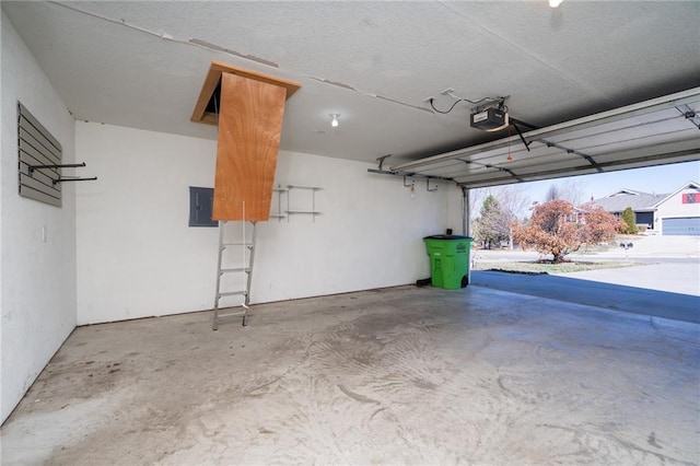 garage with electric panel and a garage door opener