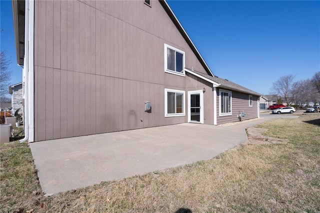 rear view of house featuring a patio area and a lawn