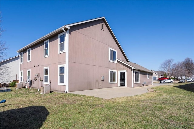 rear view of property featuring a patio and a yard