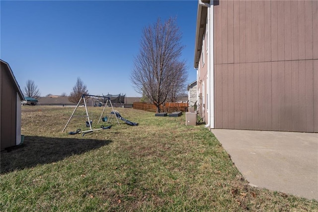 view of yard featuring fence and a playground