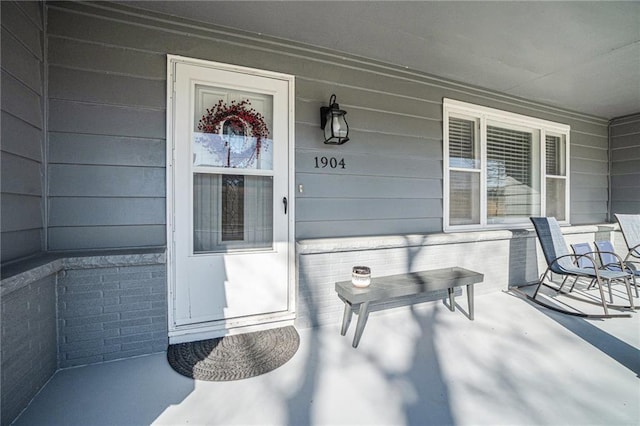 view of exterior entry featuring a porch