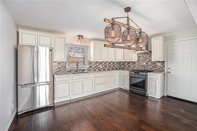 kitchen featuring dark wood-type flooring, light countertops, appliances with stainless steel finishes, white cabinets, and a sink