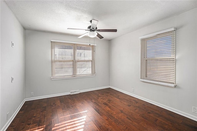 unfurnished room with visible vents, baseboards, ceiling fan, and wood-type flooring