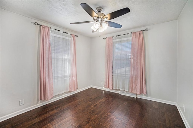 spare room featuring visible vents, baseboards, ceiling fan, a textured ceiling, and wood-type flooring