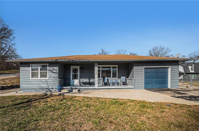 ranch-style home featuring a porch, concrete driveway, a garage, and a front yard