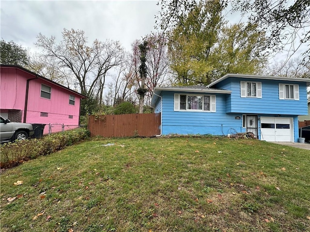 exterior space featuring a front lawn, an attached garage, and fence