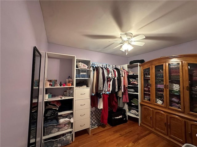 walk in closet with ceiling fan and wood finished floors