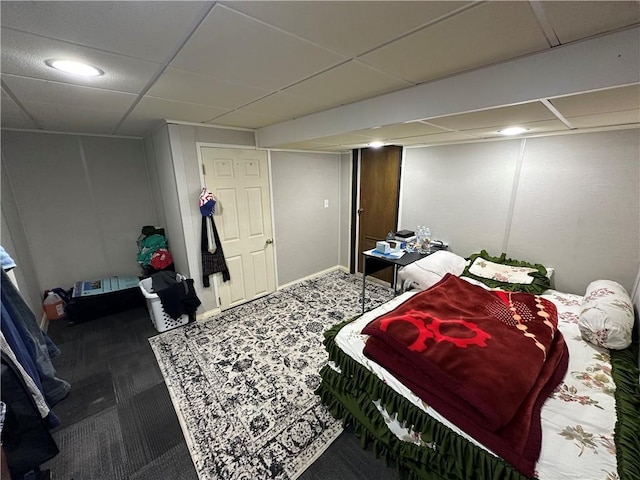 bedroom with a drop ceiling and carpet floors