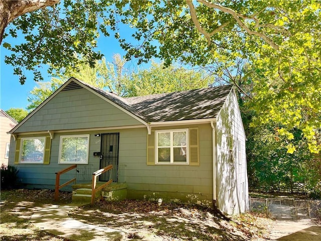 6645 Lydia Ave, Kansas City, MO 64131 - view of front of home featuring a shingled roof and fence