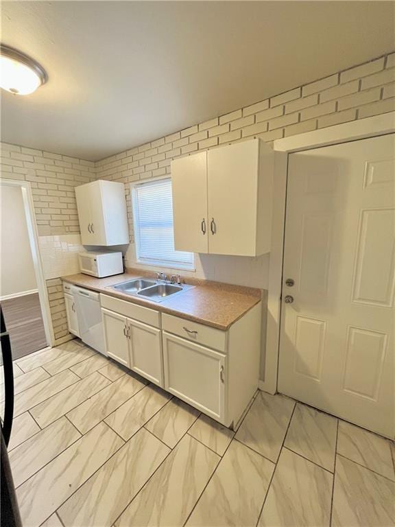 6645 Lydia Ave, Kansas City, MO 64131 - kitchen featuring white appliances, a sink, light countertops, white cabinets, and marble finish floor