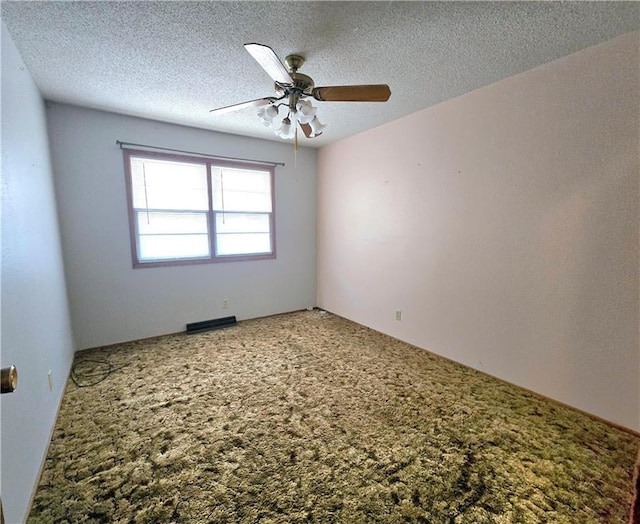 empty room featuring a ceiling fan, carpet floors, visible vents, and a textured ceiling