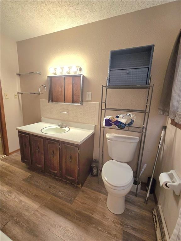 bathroom featuring decorative backsplash, vanity, toilet, and wood finished floors