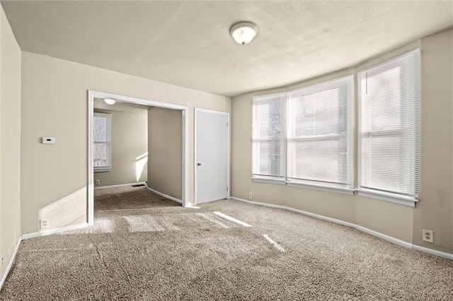 unfurnished bedroom with baseboards and carpet floors