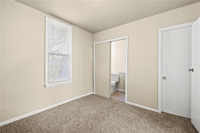 unfurnished bedroom featuring carpet and baseboards