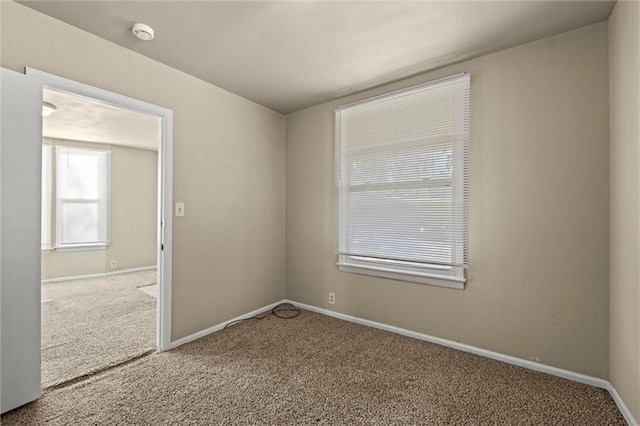 carpeted spare room with baseboards