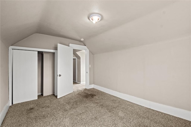 additional living space with carpet flooring and vaulted ceiling