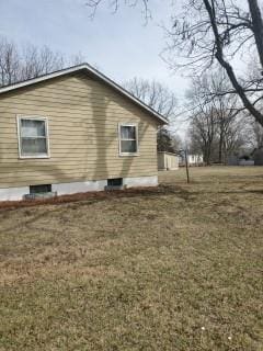 view of side of property with a lawn