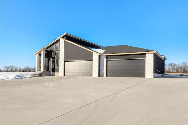 view of home's exterior featuring a garage, driveway, and stucco siding