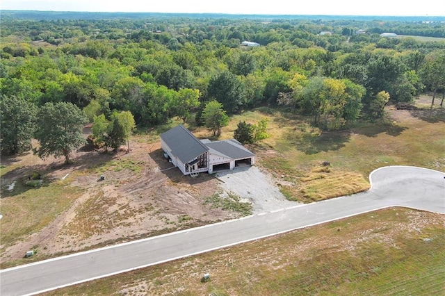 drone / aerial view with a wooded view