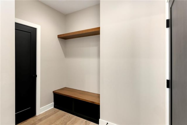 mudroom featuring light wood-style floors and baseboards