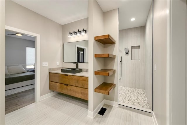 full bath with connected bathroom, a walk in shower, vanity, and baseboards