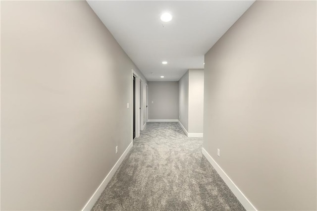 hall with recessed lighting, baseboards, and light colored carpet